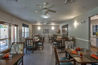Dining area with tables and chairs set for meals