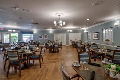 Bright dining room with tables set for meals.