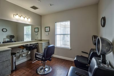 Hair salon area with styling chairs and mirrors.