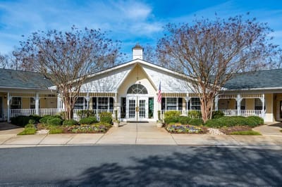 Exterior view of the facility entrance with landscaped area.