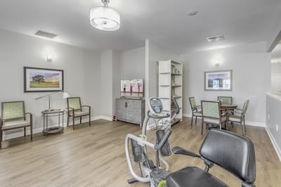 Bright activity room with exercise equipment and seating