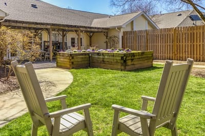 Quiet outdoor seating area with flower beds.