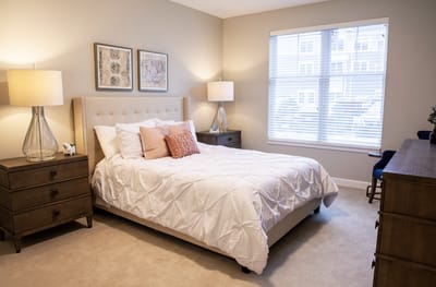 Bright private resident room with a bed and lamps