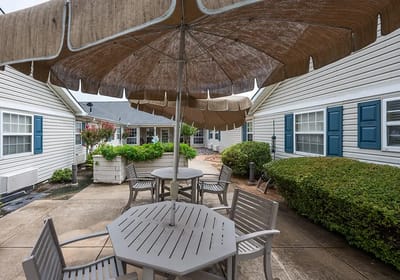 Outdoor seating area with umbrellas and landscaping