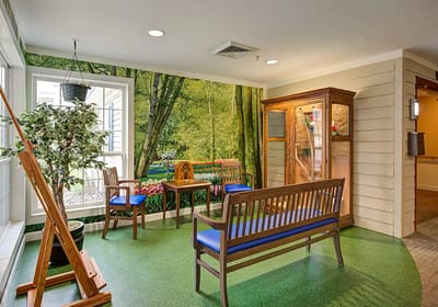 Bright common area with seating and nature wallpaper