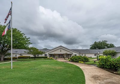 Exterior view of Arden Courts of Richardson with cloudy skies