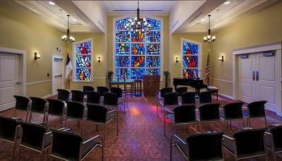 Interior view of a multi-purpose room with stained glass windows