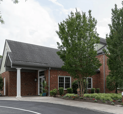 Exterior view of the Arden Courts facility with surrounding greenery.
