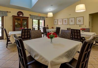 Bright dining area with tables and flower centerpieces