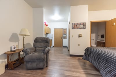 A private resident room with a recliner and kitchenette