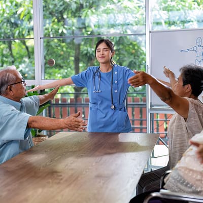 Therapist conducting group exercises with seniors