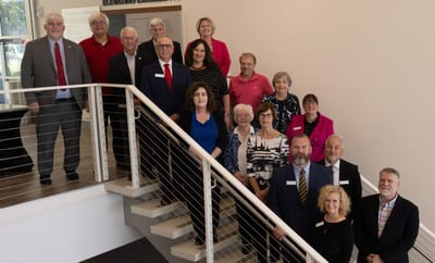 Group photo of staff in a staircase area.