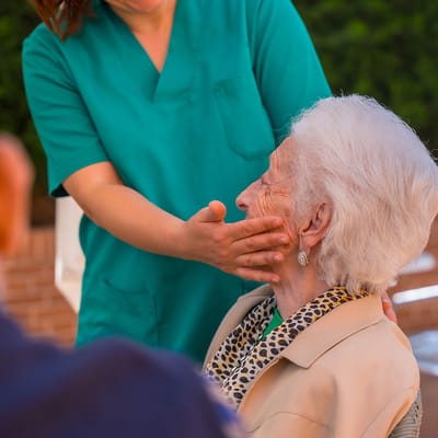 Staff member interacting with resident warmly.