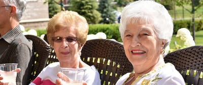 Two seniors enjoying drinks outdoors