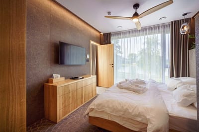 Modern bedroom with a bed and large window.