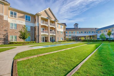Exterior view of senior living facility with landscaped grounds