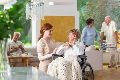 Care staff interacting with a resident in a common area