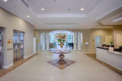 Welcoming lobby with floral centerpiece and seating area.