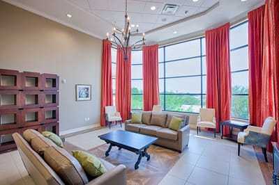 Bright common area with furniture and large windows.