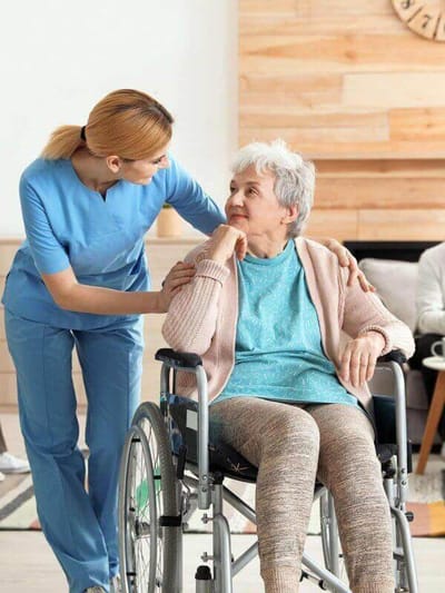Caregiver interacting with a resident in a common area.
