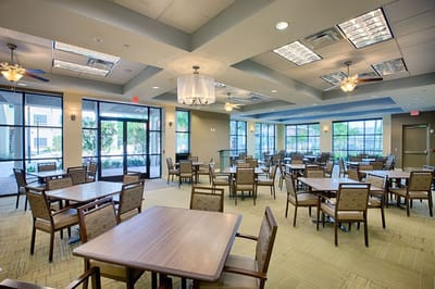 Dining room with tables and chairs set up for meals.