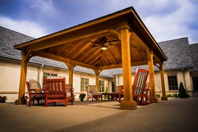 Covered outdoor seating area with wooden gazebo.