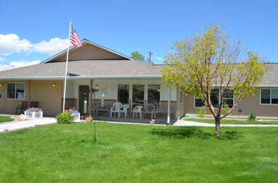 Exterior view of a senior care facility with a flag
