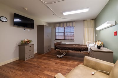 A private resident room with bed and furnishings.