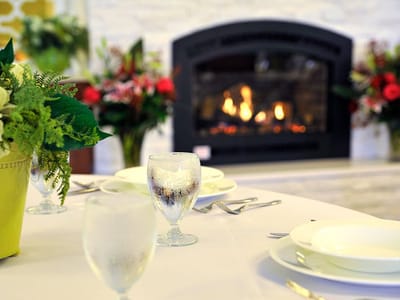 Dining table set near a cozy fireplace