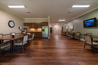Common area with dining tables and kitchenette.