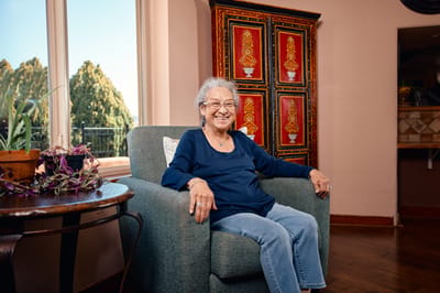 Smiling senior woman sitting in a cozy chair.