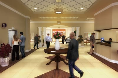 Interior common area with residents and staff interacting.