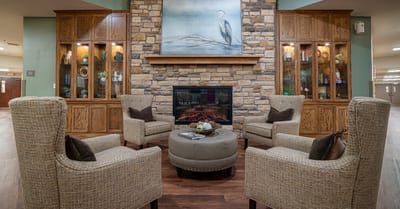 Comfortable seating area with a fireplace and art.