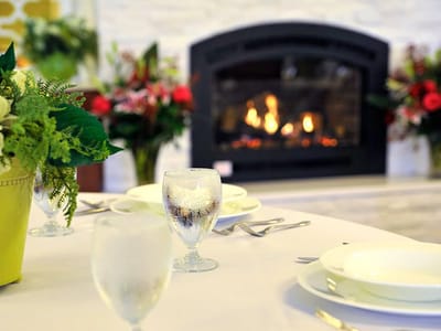 Dining setting with dishes and a cozy fireplace