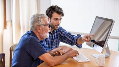 Older adult receiving assistance with technology