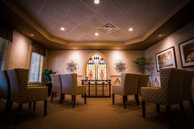 Elegant common area with stylish seating and stained glass.