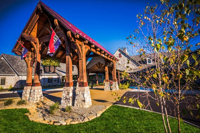 Entrance with wooden structure and flags