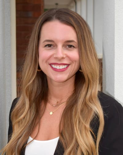 Smiling woman with long hair outdoors
