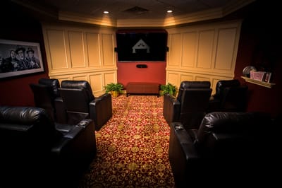 Cozy theater room with reclining chairs and decor