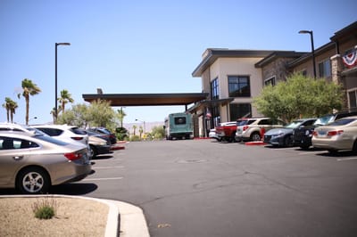 Exterior view of a senior living facility with parking