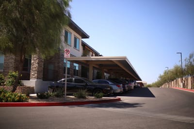 Exterior view of building with parking and trees