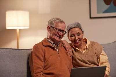 Smiling couple enjoying time together on a couch.