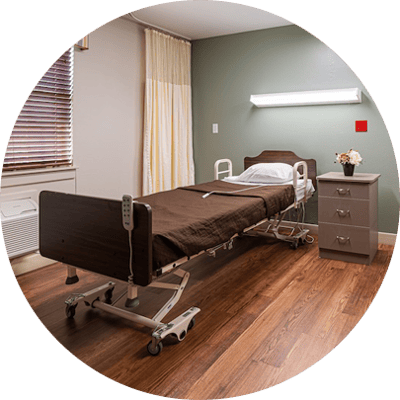 Hospital room with adjustable bed and bedside table.