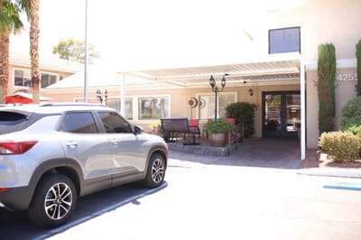 Exterior view of facility entrance with vehicle parked