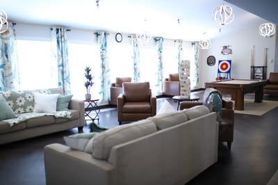 A cozy common area with comfortable seating and games
