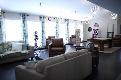 Bright interior common area with seating and games