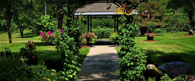 Well-maintained garden walkway with flowers and green foliage