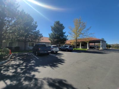 Exterior view of a senior living facility with parking lot