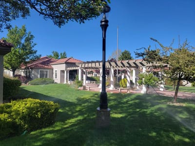 Exterior view of a senior living facility with gardens