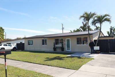 Exterior view of the assisted living facility with a resident outside